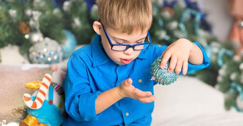 Autism-friendly Christmas - Boy playing with Christmas bauble