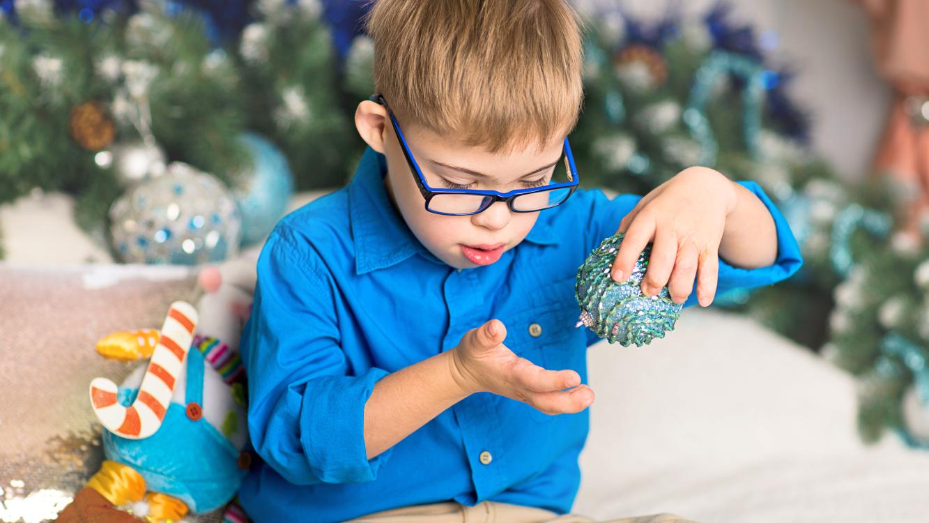 Autism-friendly Christmas - Boy playing with Christmas bauble